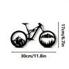 Black metal bicycle silhouette wall decor showing a mountain landscape view