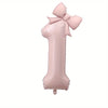 A large pink foil number balloon shaped like the number 1 with a bow.