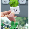 A set of four resin succulent cacti in various colors and sizes displayed on a dark surface.