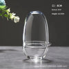 A clear glass vase with a rounded shape is shown on a dark surface, measuring 8cm in diameter and 16.5cm in height.