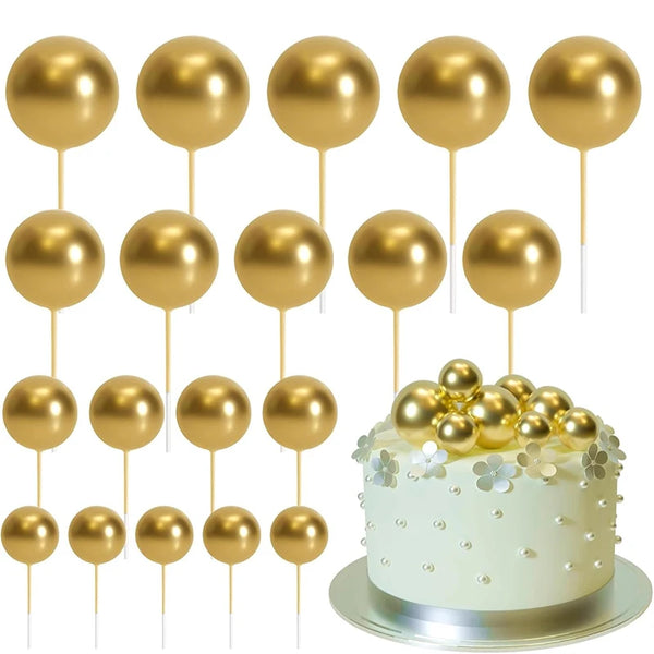 A set of twenty gold spherical cake toppers on sticks arranged in rows.