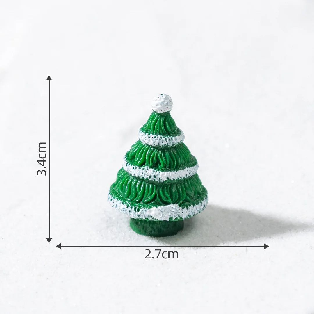 A small, green, conical Christmas tree charm with white snow accents, shown against a white background.