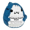 A hand-woven blue and white shark plush pendant with a smiling expression and an encouraging card.