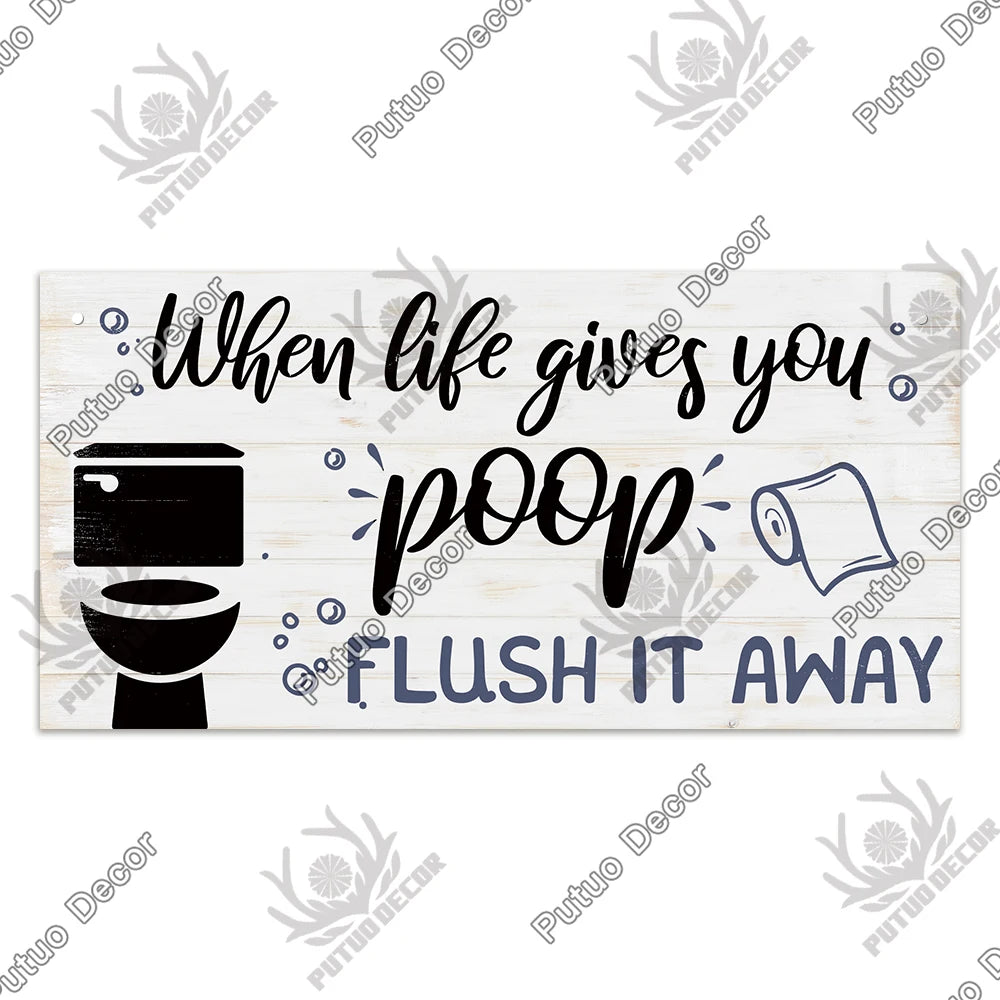 A rustic wooden sign with black silhouette of a toilet and text that reads When life gives you poop flush it away