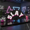 A black clapper hand fan with the word SLAY printed on it, illuminated by neon lights.