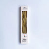 A vertical box of curved metallic birthday cake candles with a gold finish.