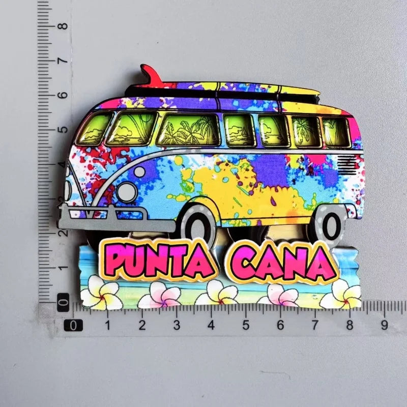 A colorful wooden fridge magnet shaped like a yellow bus with purple accents and floral details.