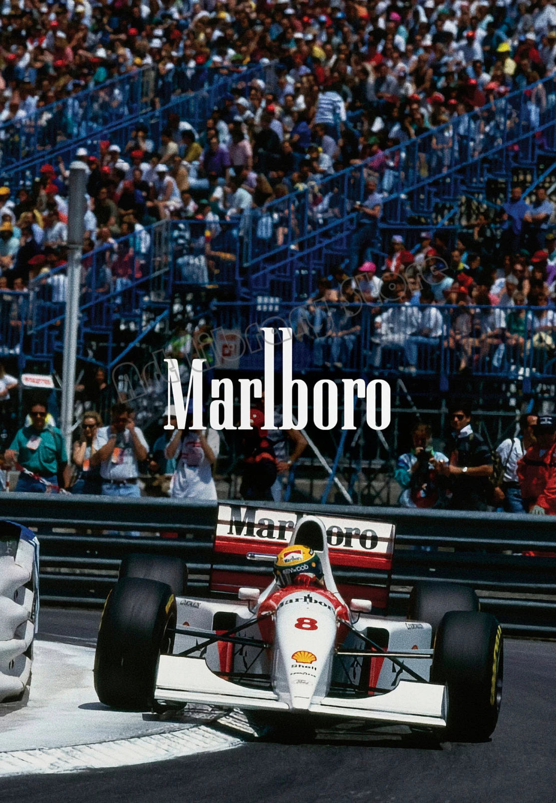 A vintage Formula 1 car is visible on the track with a large crowd in the background.