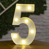 A glowing warm white LED alphabet letter light shaped like the number five resting on a wooden surface.