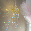 A golden crystal hanging suncatcher decoration with dangling clear and colored glass elements.