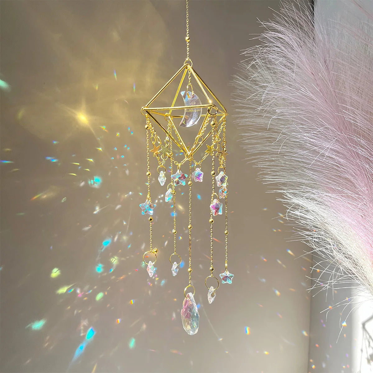 A golden crystal hanging suncatcher decoration with dangling clear and colored glass elements.