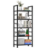 A black metal bookshelf with five tiers displaying books, decorative items, and a small Christmas tree.