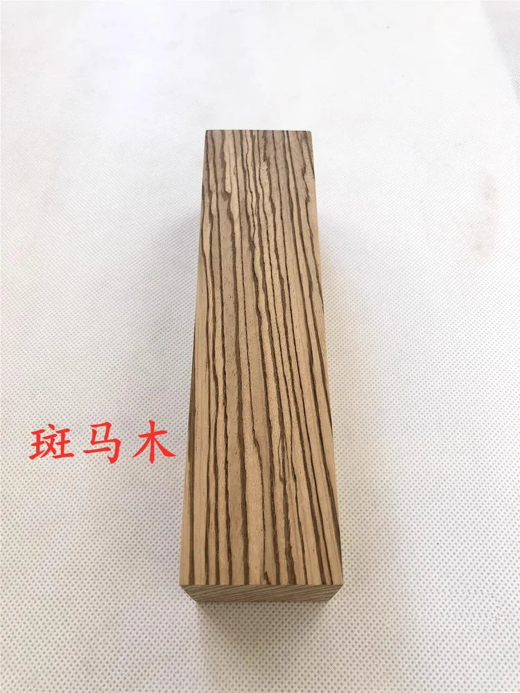 A vertical rectangular block of natural wood, used as a blank for knife handles and DIY projects.