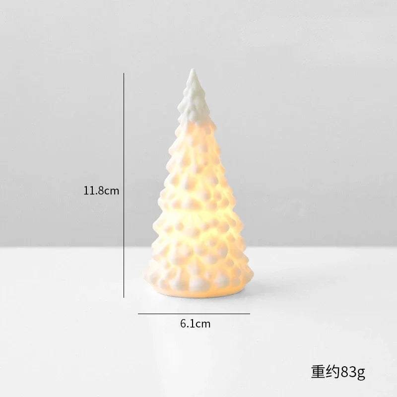 A small, white ceramic glow-in-the-dark Christmas tree decor shaped like a cone.