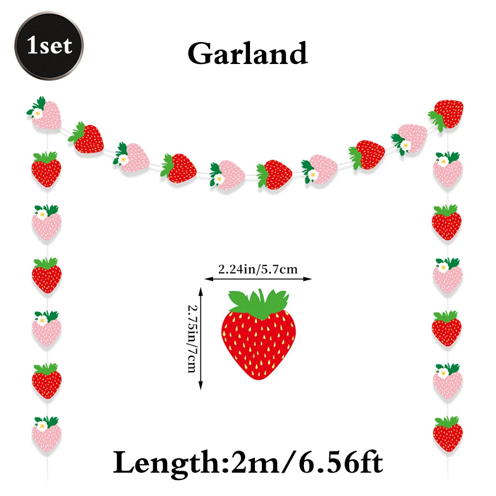 A garland of strawberry-shaped decorations for a birthday party, including individual strawberries and a central fruit.