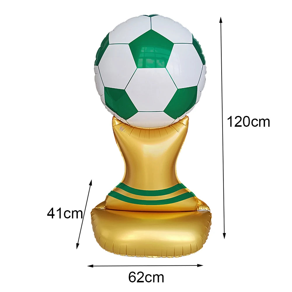 A standing soccer balloon featuring a green and white football on top, supported by a gold base.