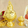 A gold-plated Orthodox censer with bells hanging by a chain, set against a beige background.