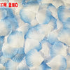 White and blue silk rose petals scattered on a surface for weddings and events
