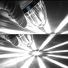 A hand holds a clear LED side marker light, illuminating bright beams against a dark background.