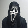 A person wearing a realistic Scream Ghost Face mask with a gaping mouth and hood against a light gray background.