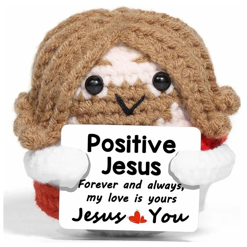 A handcrafted crochet animal doll with brown hair and white fur, holding a card that reads Positive Jesus Forever and always 