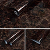Close-up view of a silver self-adhesive marble contact paper being applied to a dark brown marble surface.