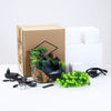 A brown cardboard box containing a resin waterfall desktop fountain with LED lighting and associated accessories.