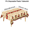 A beige disposable plastic tablecloth featuring a vintage Christmas design with red poinsettias and brass bells.