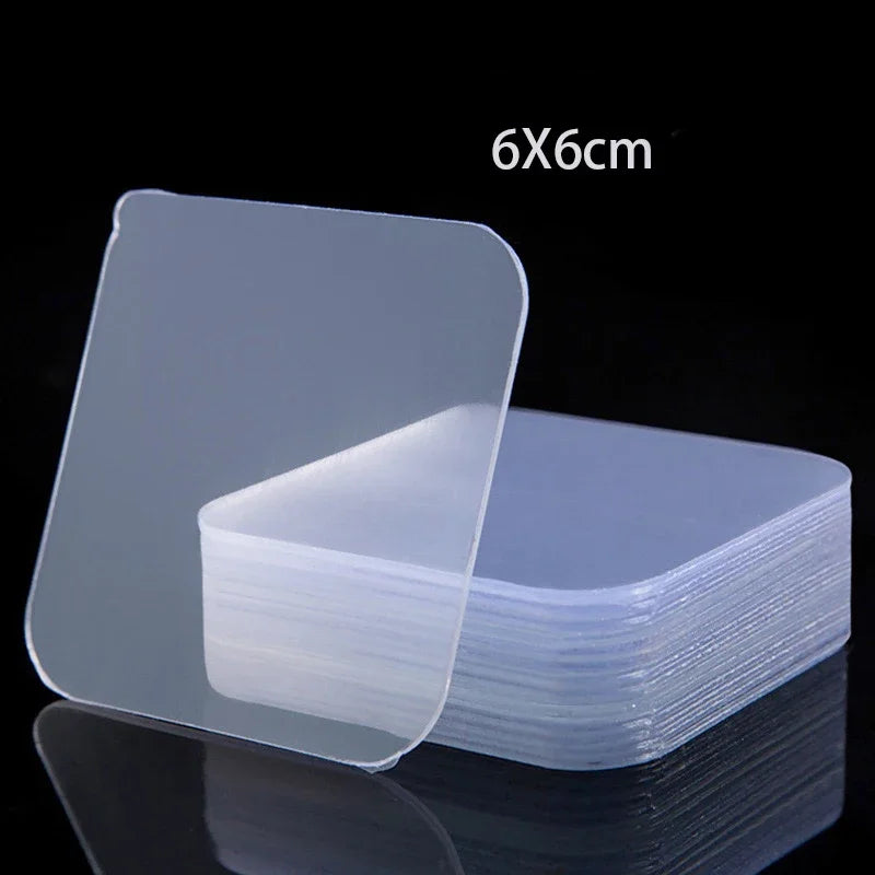 A stack of clear, double-sided adhesive tape sheets measuring 6x6cm.