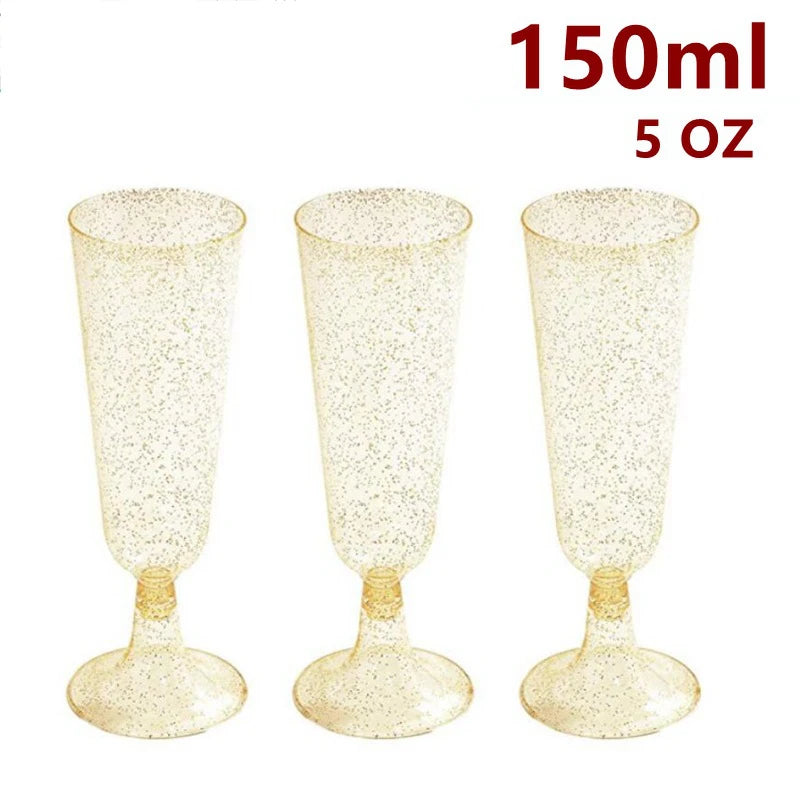 Three clear plastic champagne flutes with gold glitter detailing shown against a white background.