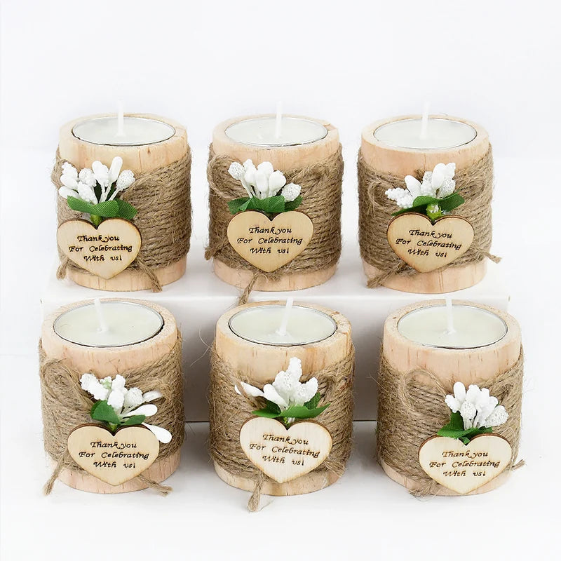 Six natural wooden candle holders wrapped in twine with a thank you message tag
