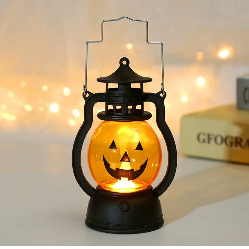 A black hanging lantern with an orange glow shaped like a carved jack-o'-lantern face.