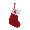 A red knitted sock with a white letter K and a red loop for tree decoration.