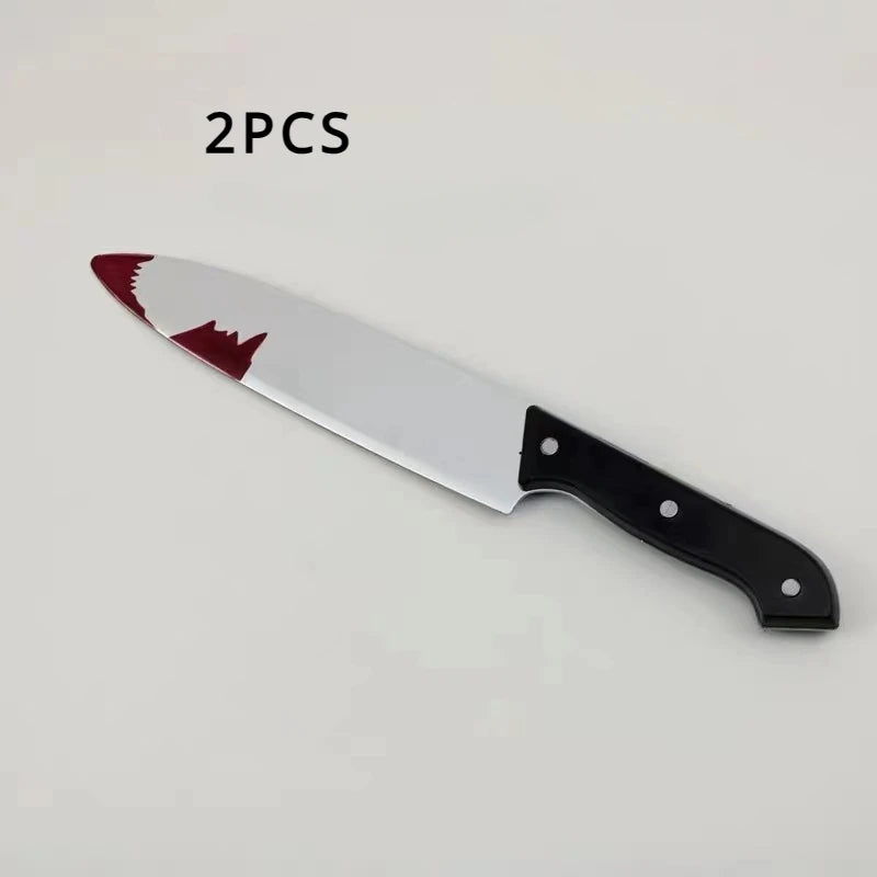 A realistic bloody knife prop with a white blade and red blood stain on the edge, shown against a light background.