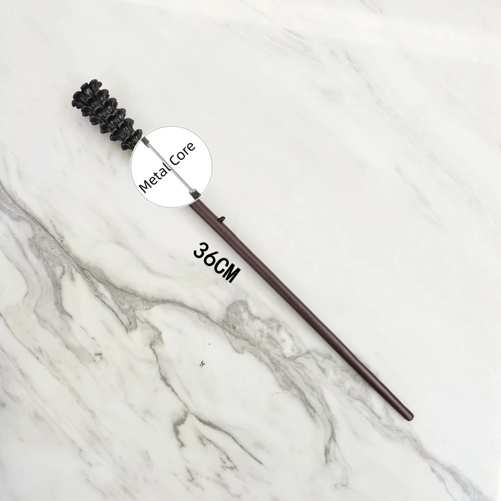 A dark metal magic wand replica with a textured handle and a circular metal core resting on a white marble surface.