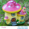 A colorful resin mushroom house garden statue with pink and yellow accents.