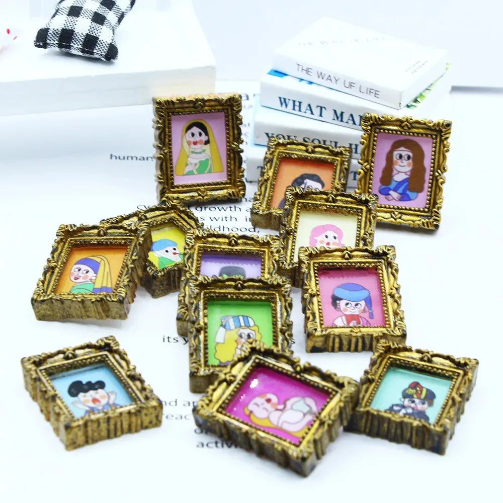 A collection of miniature framed wall art featuring colorful illustrations of dolls and characters.