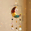 A hanging crystal dreamcatcher sun catcher featuring a crescent moon shape with colorful crystals and dangling charms.