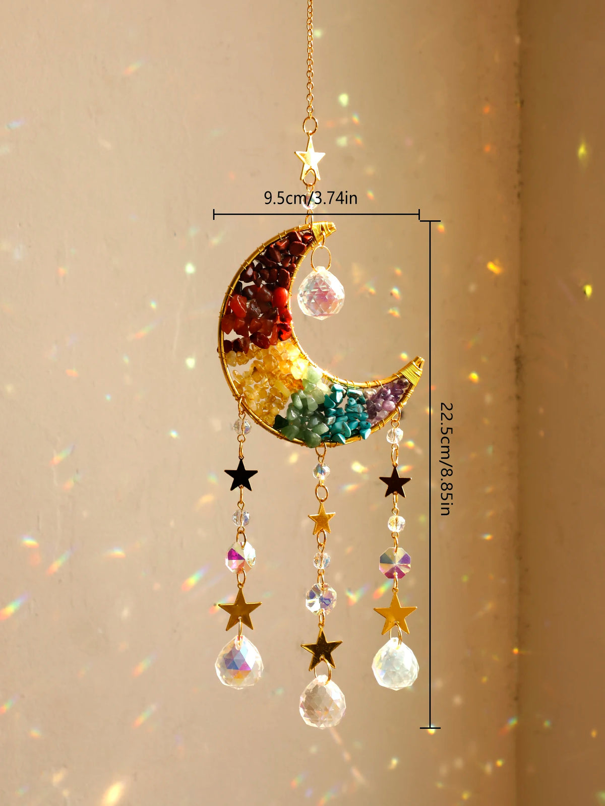 A hanging crystal dreamcatcher sun catcher featuring a crescent moon shape with colorful crystals and dangling charms.
