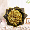 A bouquet of twelve artificial gold glitter roses presented in a dark brown, star-shaped box.