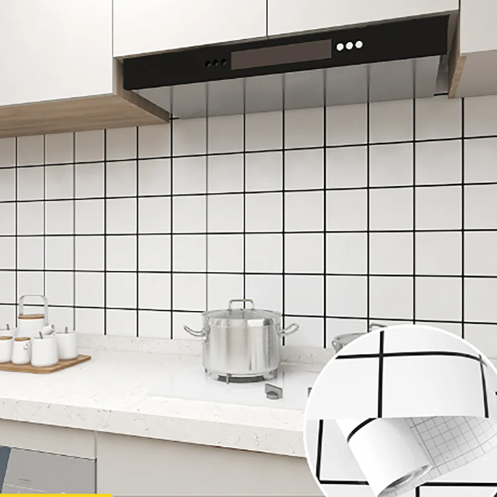 A modern kitchen featuring a stainless steel range hood above a white tiled backsplash and countertop.