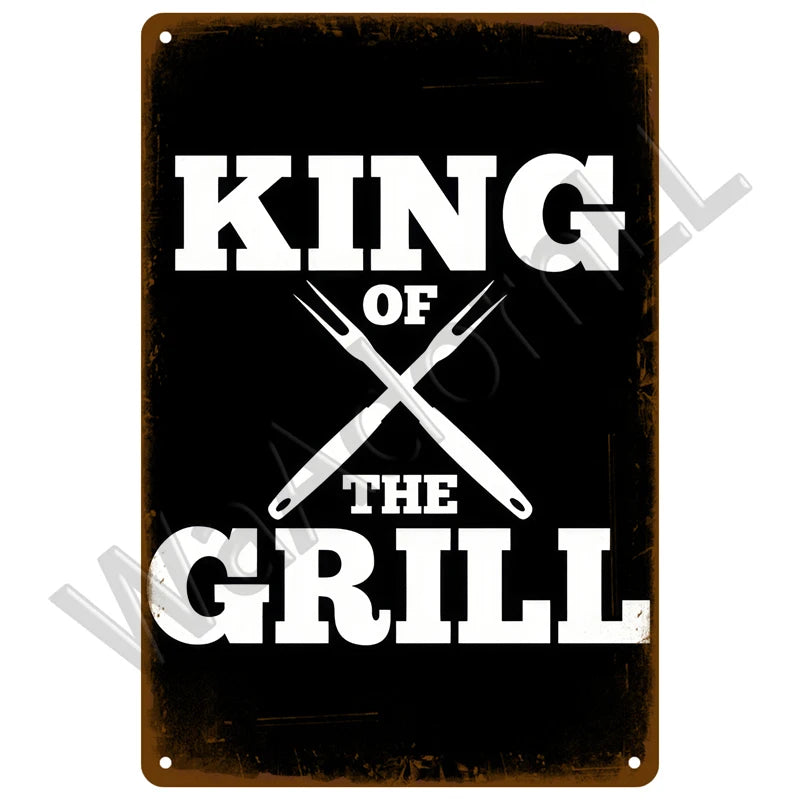 A black metal tin sign with white text that reads KING OF THE GRILL.
