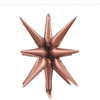 A cluster of rose gold star burst foil balloons for party decor