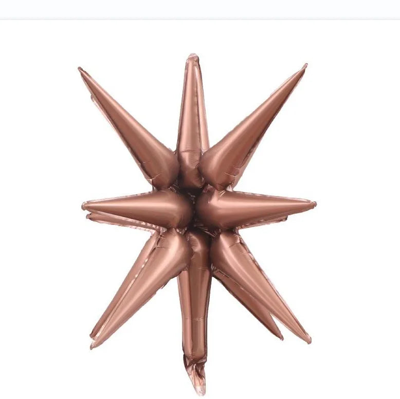 A cluster of rose gold star burst foil balloons for party decor
