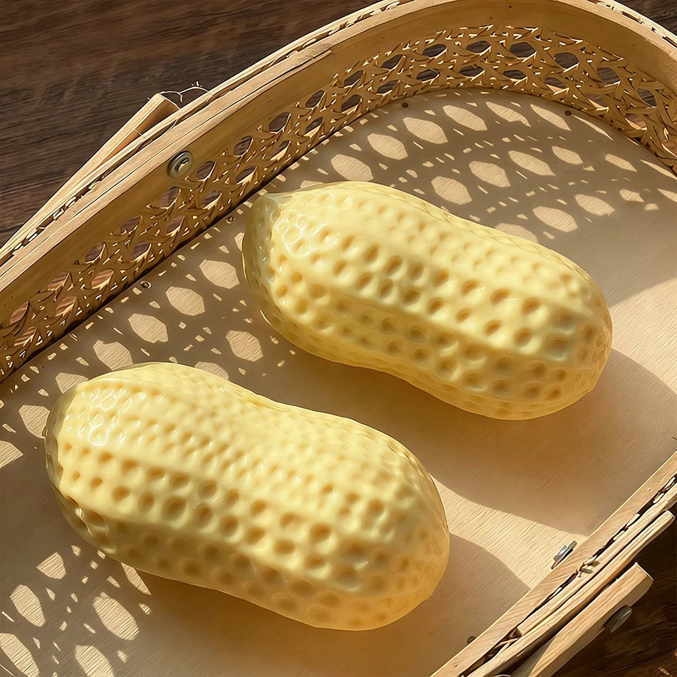 A yellow peanut-shaped stress ball is shown resting on a wooden tray.
