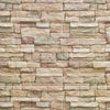 A textured stone veneer wall made of rectangular, stacked panels in beige and brown tones.