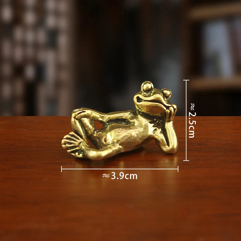 Antique brass sleeping frog figurine with dimensions 3.9cm long and 2.5cm high