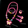 A set of pink and purple beaded jewelry including a necklace and butterfly hair clips.