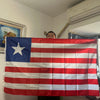 A decorative banner displaying the flag of Liberia with red and white stripes and a blue canton.