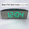A digital LED alarm clock displaying 12:04 on a dark gray screen with control buttons.
